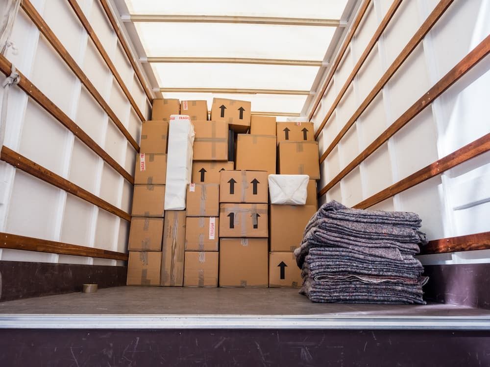 Cardboard boxes stacked in moving van